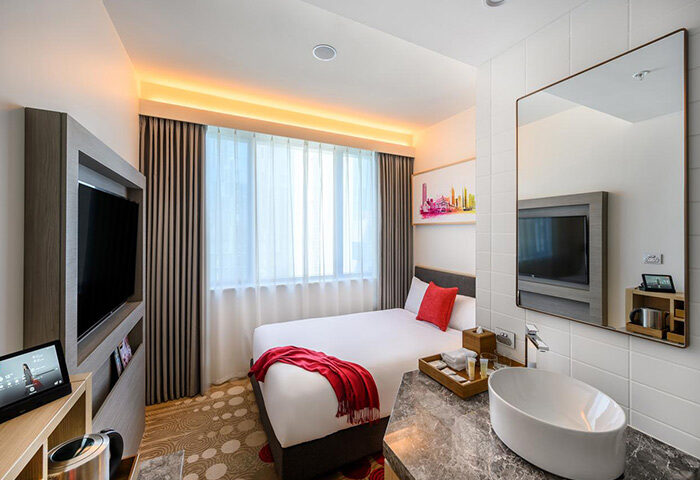 Ibis Melbourne Central hotel room. Modern design with bed, TV, and stylish bathroom. Gay-friendly accommodation in Melbourne, Australia.