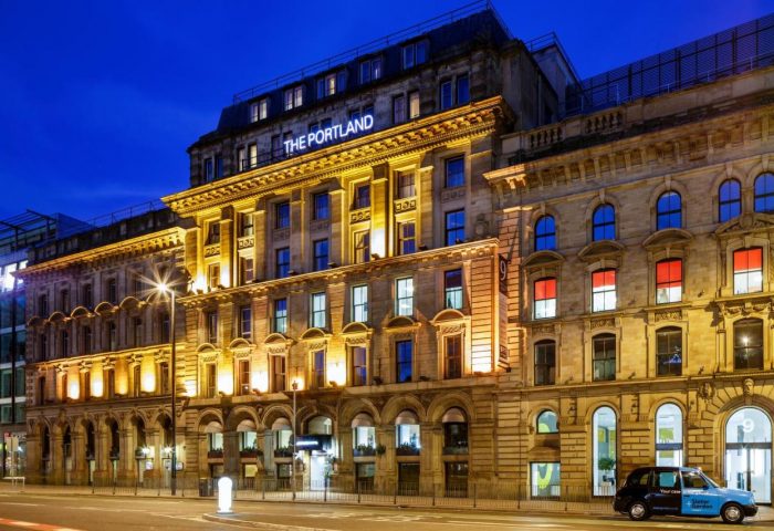 Ibis Styles Manchester Portland, a gay-friendly hotel. Exterior view at night, showcasing its architecture and welcoming ambiance for gay travelers.