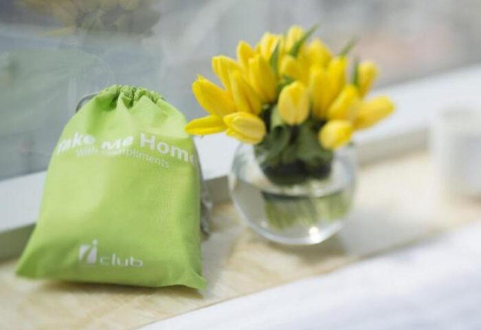 iclub Sheung Wan Hotel detail: Take me Home bag with compliments and a vase of yellow tulips. Gay-friendly hotel welcome gift.