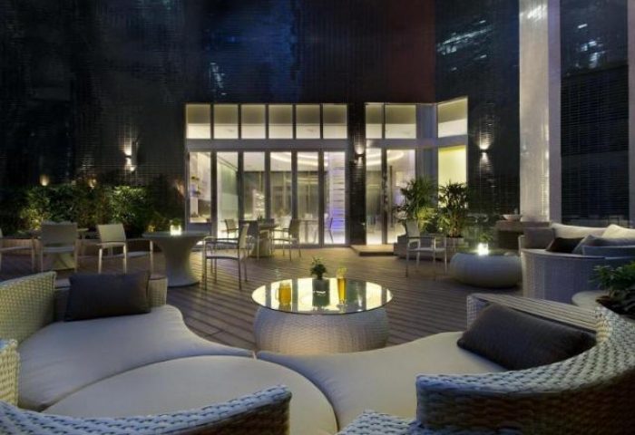 iClub Sheung Wan Hotel's stylish terrace at night. A gay-friendly hotel with outdoor seating, drinks, and modern design. Perfect for relaxing.