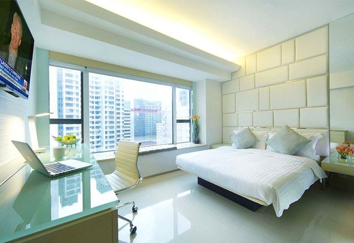 Gay-friendly iclub Sheung Wan Hotel room. Modern design with a bed, desk, and city view. A comfortable stay in Hong Kong for gay travelers.