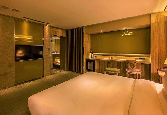 Inhouse Boutique gay-friendly hotel room. Modern design with TV, desk, and bathroom. Ideal for gay men travel.