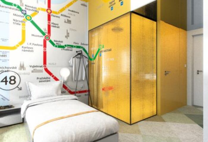 meetme23 gay-friendly hotel room. Pet-friendly stay with single bed, golden wardrobe, and Prague metro map design on the wall. Gay travel advice.