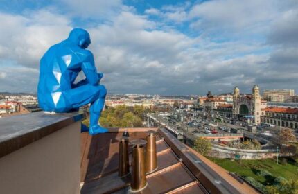 meetme23 Gay-Friendly Hotel rooftop view featuring a blue statue overlooking Prague. Pet-friendly lodging with city views.
