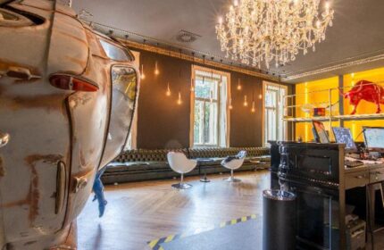meetme23 gay-friendly hotel lobby. Pet-friendly space with unique decor, chandelier, and vintage car detail. Great for gay travel.