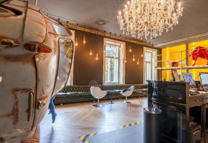meetme23 gay-friendly hotel lobby. Pet-friendly space with unique decor, chandelier, and vintage car detail. Great for gay travel.