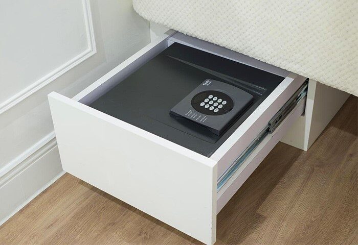 Gay-Friendly Hotel mini hotel Central: Open drawer with safe. Security for gay travelers. Central hotel room detail. Safe travels for gay men.