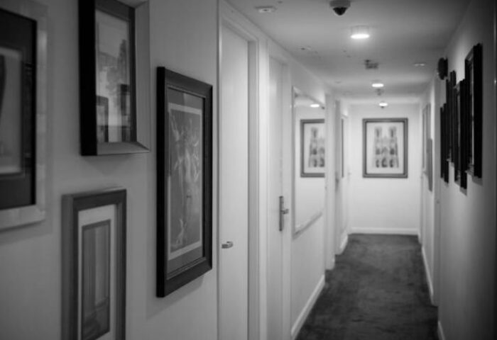 Mini Hotel Central hallway. Gay-friendly hotel with art-lined walls. Central location for gay travelers. Interior design. Black and white.