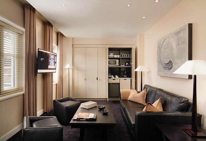 The Resident Soho, gay-friendly hotel in London. Living room with kitchen. The Nadler Soho features modern amenities for a comfortable stay.