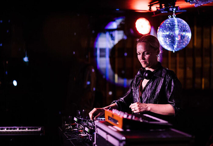 DJ at Generator Copenhagen, a gay-friendly hotel with bars in Nyhavn. Nightlife scene with a disco ball. Perfect for gay travelers.