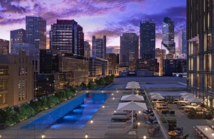 Le Meridien Melbourne gay hotel rooftop pool view. Melbourne skyline at dusk. Gay travel accommodations and luxury hotel experience.