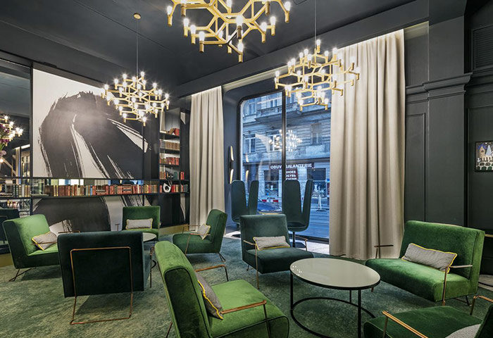 Hotel Century Old Town Prague-MGallery lobby. Green velvet chairs, modern chandeliers. Gay-friendly hotel near Prague's gay bars/saunas.