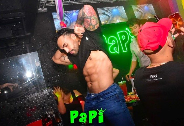 Gay Mexico City nightlife: Man with abs at Papi club. Gay travel guide image of a shirtless man dancing in a Mexico City gay bar.