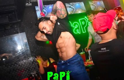 Gay Mexico City nightlife: Man with abs at Papi club. Gay travel guide image of a shirtless man dancing in a Mexico City gay bar.