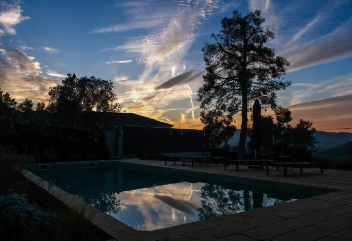 Casa Brisa Boutique Guest House pool at sunset. Gay-owned guest house offers a tranquil retreat for gay men seeking relaxation.