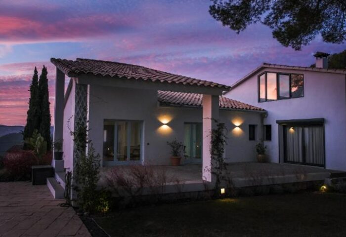 Casa Brisa Boutique Guest House exterior at dusk. Gay-owned guesthouse with illuminated patio and garden. Travel advice for gay men.