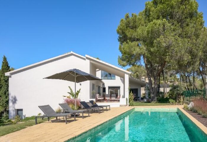 Casa Brisa Boutique Guest House pool view. Gay-owned guesthouse with sun loungers and umbrella. Perfect for gay travel & relaxation.