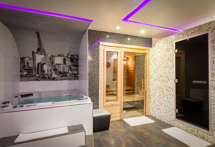 L'Empire Paris Hotel spa with jacuzzi, sauna, and steam room. Gay-popular hotel near gay bars. Eiffel Tower mural on the wall.