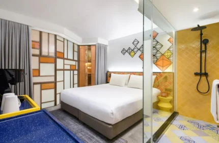 Ibis Styles Bangkok Silom hotel room. Stylish gay hotel with bed, shower, and colorful decor. Gay-friendly travel in Silom, Bangkok.