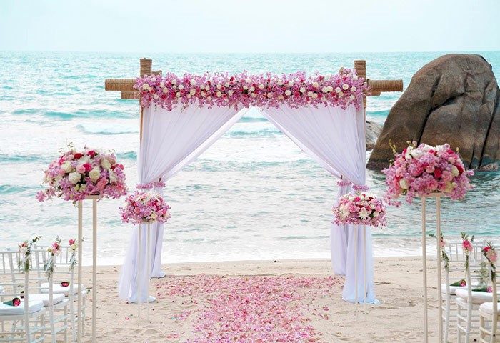 Beach wedding at Silavadee Pool Spa Resort, Koh Samui. Floral archway and aisle for a gay wedding. Romantic destination for LGBTQ+ couples.