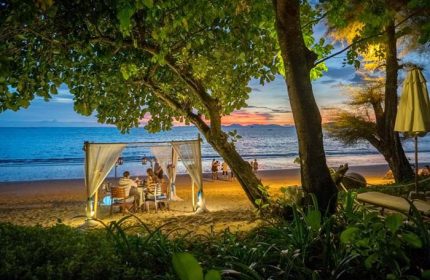 Romantic beach dinner at Centara Grand Krabi, a gay-friendly hotel. Sunset views, soft lighting, and intimate setting. Perfect for couples.