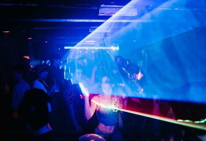 GenderFunk Ho Chi Minh nightlife. People dancing at a gay party with blue and red lights, enjoying gay travel in Vietnam.