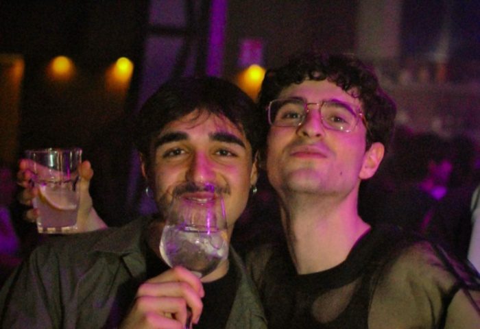 Two gay men enjoying drinks at Glamorize Roma, a gay party in Rome, Italy. Nightlife scene with drinks and friends. Gay travel advice.
