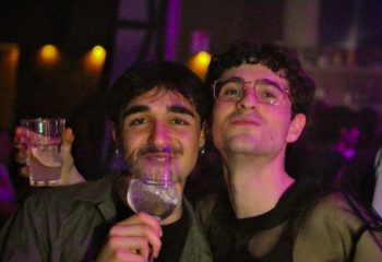 Two gay men enjoying drinks at Glamorize Roma, a gay party in Rome, Italy. Nightlife scene with drinks and friends. Gay travel advice.