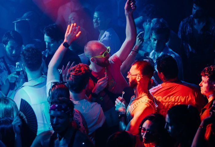 Crowd at Glitterbox @ Hi Ibiza gay club, men dancing under blue & red lights. Ibiza nightlife for gay men travel advice.