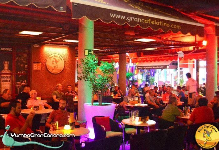 Gran Cafe Latino gay bar in Gran Canaria's Yumbo Centre. People are enjoying drinks in this popular gay venue.