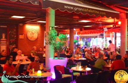 Gran Cafe Latino gay bar in Gran Canaria's Yumbo Centre. People are enjoying drinks in this popular gay venue.
