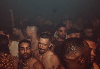 HUSH HK Gay Bar Dance Club in New York: A crowd of gay men partying at a dance club in New York City. Nightlife scene.