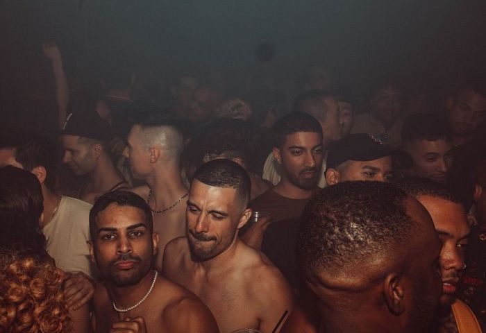 HUSH HK Gay Bar Dance Club in New York: A crowd of gay men partying at a dance club in New York City. Nightlife scene.