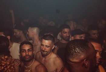 HUSH HK Gay Bar Dance Club in New York: A crowd of gay men partying at a dance club in New York City. Nightlife scene.