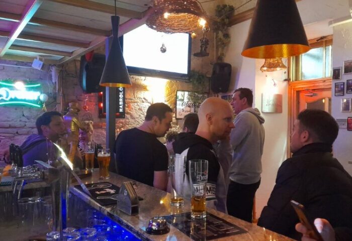 Habrolo Cafe Bar Budapest interior. Gay bar scene with men at the counter. Budapest gay travel advice, gay nightlife, and gay bar scene.