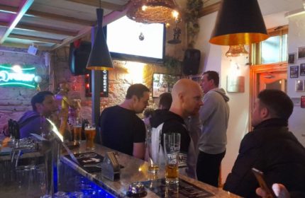 Habrolo Cafe Bar Budapest interior. Gay bar scene with men at the counter. Budapest gay travel advice, gay nightlife, and gay bar scene.