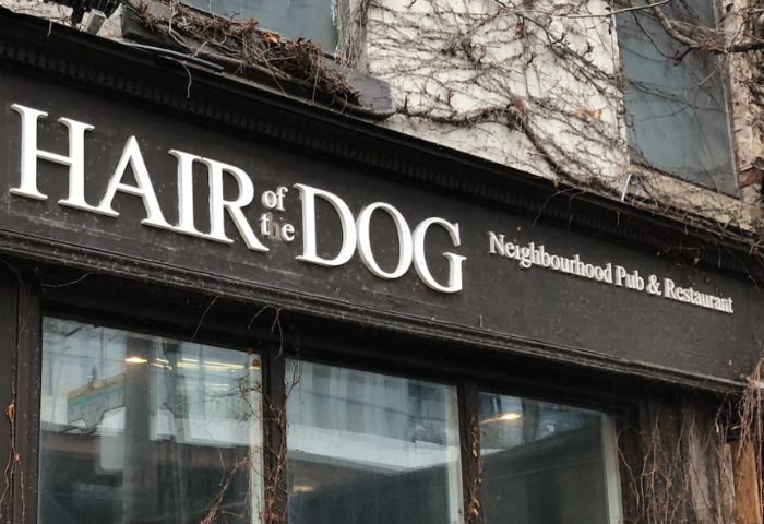 Hair of the Dog Pub sign in Toronto. Gay travelers' guide to this neighborhood pub and restaurant. Toronto's LGBTQ+ friendly bar.