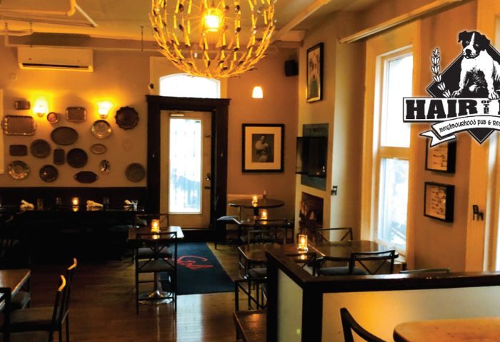 Interior view of Hair of the Dog Pub in Toronto. Warm lighting, tables, and decor create a cozy atmosphere. Gay travel recommendation.