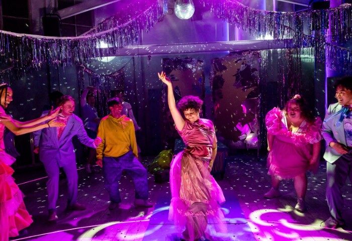 Heaps Gay Sydney party scene. People dancing under disco ball, colorful outfits. Nightlife for gay men, travel advice, Sydney's LGBTQ scene.