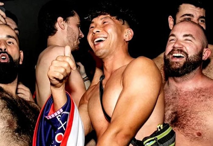 Heaven Paris: Gay men enjoying a party. Shirtless men smiling and laughing, one giving a thumbs up. Nightlife scene in Paris. Heaven-Paris.jpg