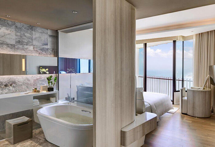 Hilton Pattaya honeymoon suite. Luxury gay hotel near Pattaya Beach, Thailand. Modern bathroom and bedroom with ocean view.