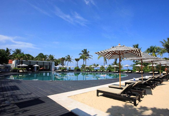 Hilton Phuket Arcadia Resort & Spa pool view. Perfect gay honeymoon hotel in Phuket with pool, beach umbrellas, and lounge chairs.
