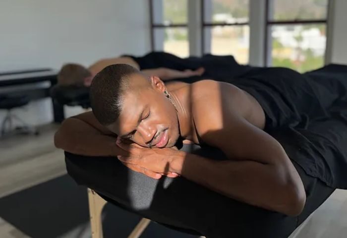 Relaxation massage in Hollywood. A gay man lies face down on a massage table, eyes closed, enjoying a Hollywood Massage Relaxation treatment.