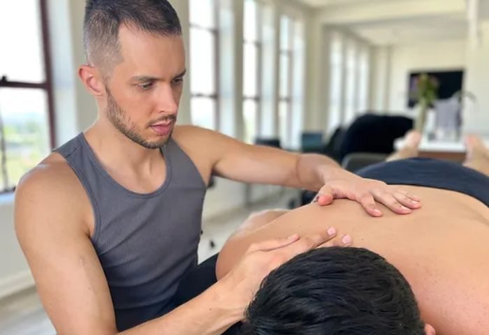 Gay masseur giving a Hollywood massage service. Man receiving back massage in a bright room. Hollywood-Massage-Service.jpg
