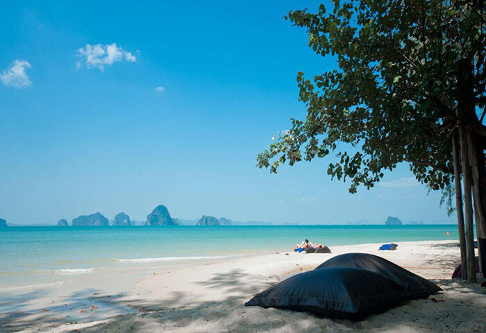 Krabi's Tubkaak Boutique Resort beach view. Honeymoon destination for gay men. Luxurious hotel with ocean, islands, and bean bag chairs.