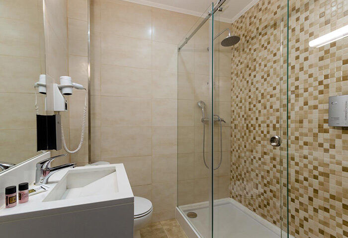 Hotel Borges Chiado bathroom. Modern shower, sink, & hairdryer. Most booked gay hotel in Lisbon's gayborhood for gay men travelers.