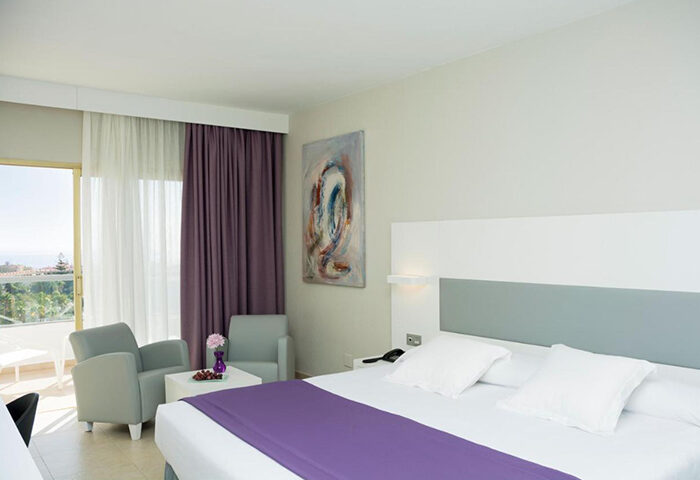 Hotel Gran Canaria Princess adults-only room. Modern decor, balcony, and seating area. Popular gay hotel for Gran Canaria travel.
