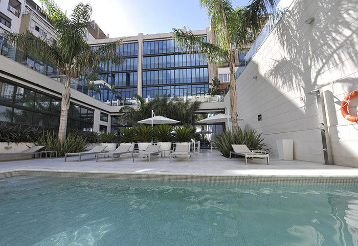 Hotel Indigo Barcelona Plaza Catalunya pool. Best gay-friendly hotel Barcelona with room for 3 adults. Relaxing gay travel destination.