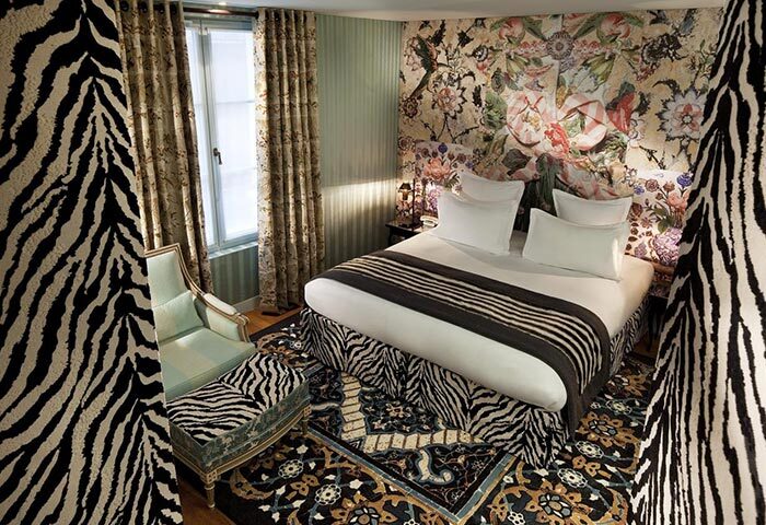 Hotel du Petit Moulin, Paris. Best gay hotel in Marais gayborhood. Stylish room with zebra print and floral wall. Gay travel advice.