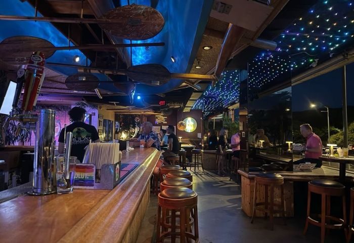 Interior of Hula's Bar and Lei Stand in Honolulu. Gay bar with music, drinks, and tropical decor. Popular gay travel destination.